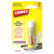 Verpackung eines CARMEX Vanilla Lippenbalsam Sticks mit SPF 15. Vanilleblüte und -stange im Hintergrund.
