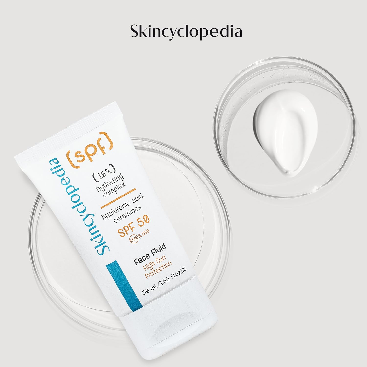 Weiße Tube SKINCYCLOPEDIA SPF 50 Fluid, daneben eine Schale mit Fluidcreme.