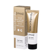 Tubo e embalagem em tons de dourado e branco do creme para os olhos SKINCYCLOPEDIA com Matrixyl e cafeína, sobre fundo branco