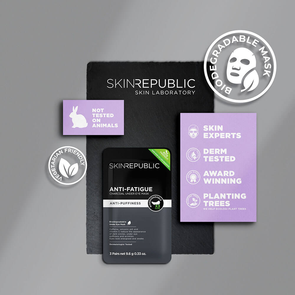 Produktanordnung von "Skin Republic"-Augenmasken und Werbematerialien auf einer Schieferoberfläche, die grausam-freie, vegetarische und biologisch abbaubare Aspekte aufweist.