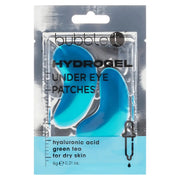 Verpackung mit zwei blauen Hydrogel-Augenpads. Text hebt Hyaluronsäure und Grüntee hervor. Für trockene Haut. Pipette mit Tropfen als Symbol.