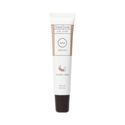 FRANK BODY Taupe-less Lip Tint num tubo branco de 15 ml com tampa castanha escura, sobre fundo branco