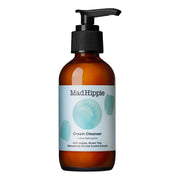 MAD HIPPIE Cream Cleanser num frasco de vidro castanho com um dispensador de bomba preto e um rótulo azul-claro sobre fundo branco
