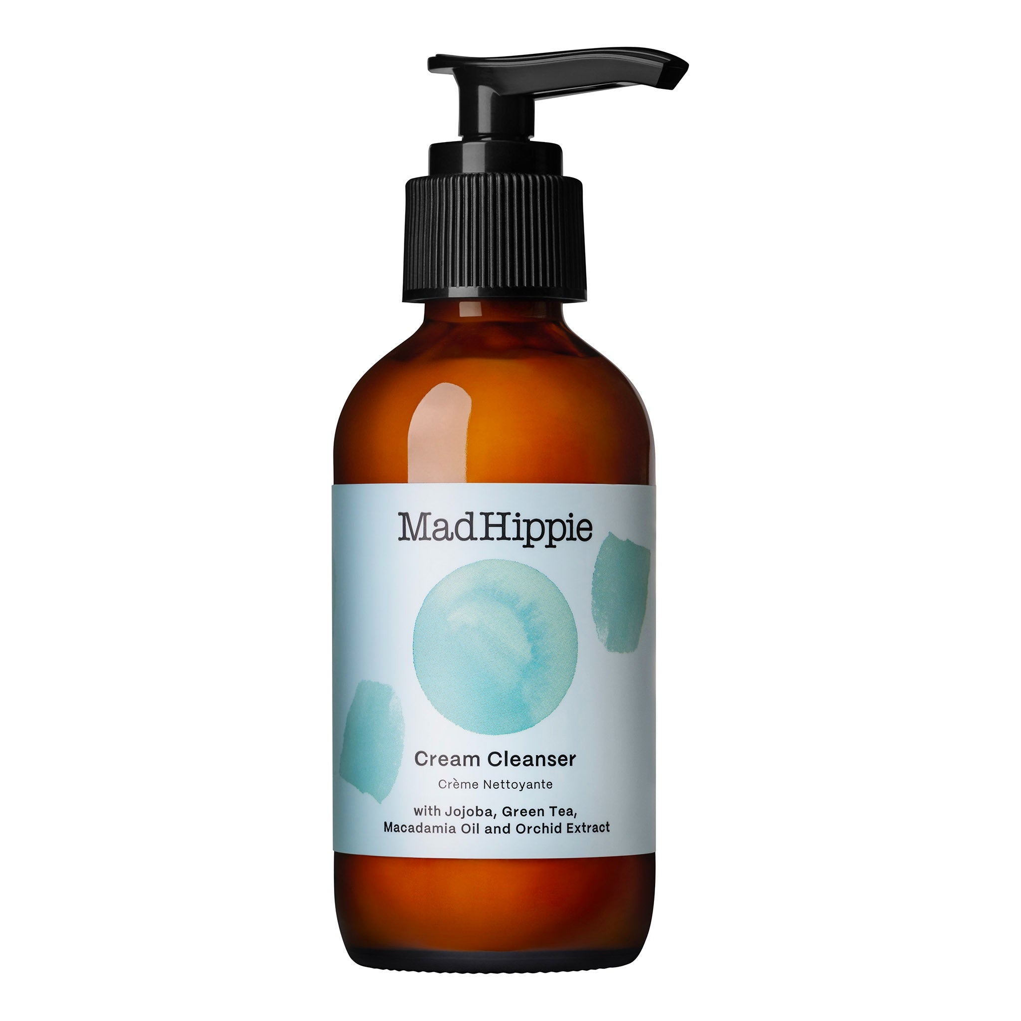 Braune Glasflasche mit schwarzem Pumpspender und hellblauem Etikett. Aufschrift: Mad Hippie Cream Cleanser mit Jojoba, Grüntee, Macadamia Öl und Orchideenextrakt.