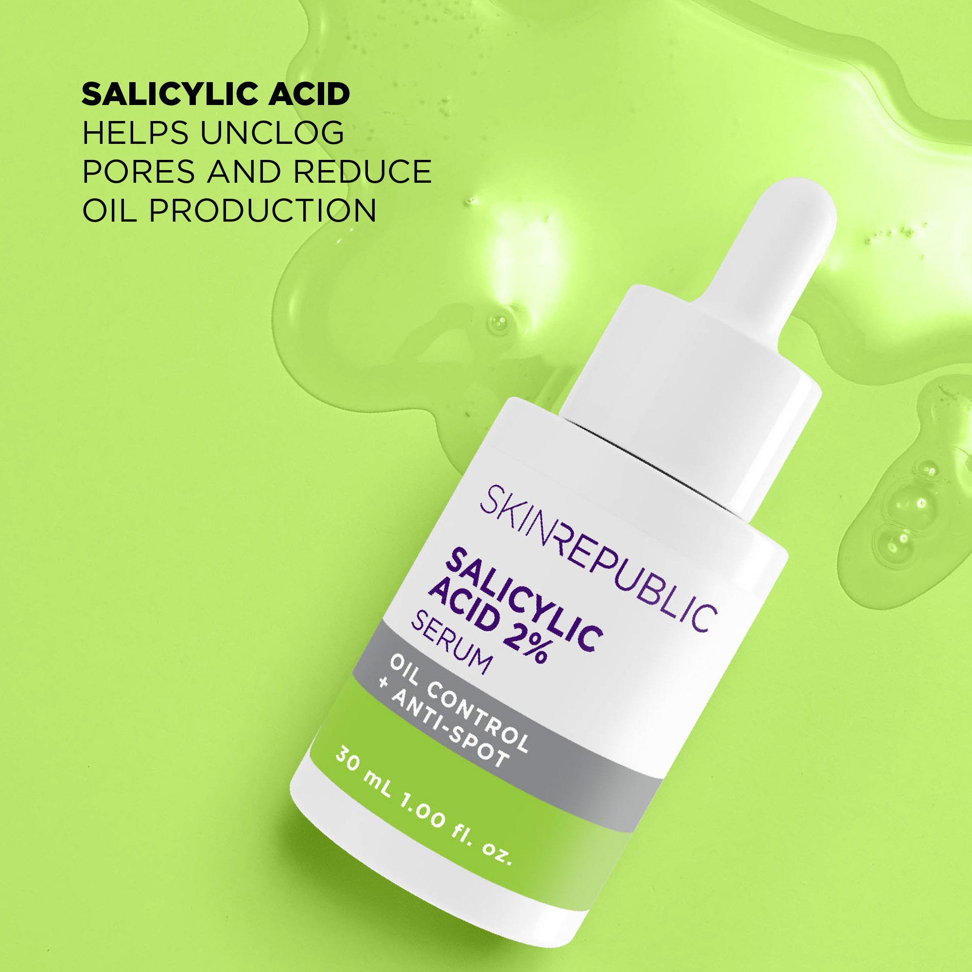 Ein Serumfläschchen auf hellgrünem Hintergrund mit Serumtropfen. Das Etikett ist weiß mit lila Schrift und grünen Akzenten. Es ist beschriftet mit "Salicylic Acid 2%".