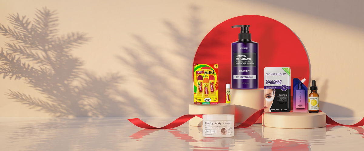 Geschenkideen von BONSANA im Abendlicht mit roter Schleife: KUNDAL, Carmex Minis, Skin Republic, HIDEHERE, Mad Hippie, frank body